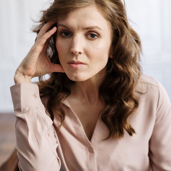 Person taking a calm deep breath in an office.